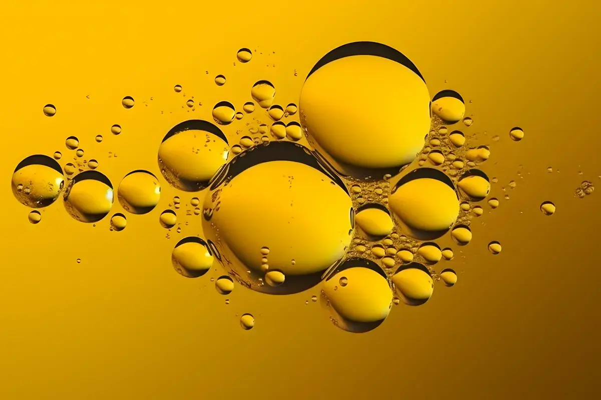 Abstract texture of golden oil bubbles on a yellow background