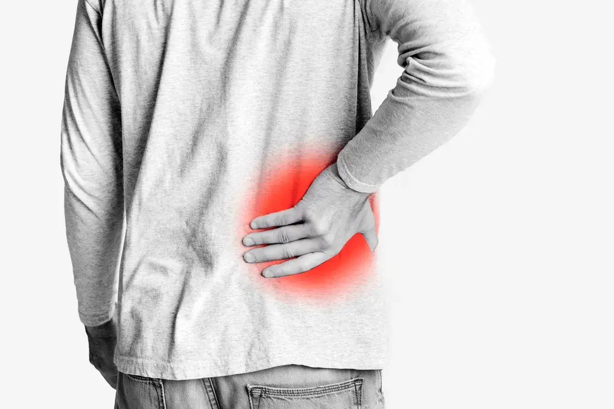 Young man experiencing back pain associated with kidney problems