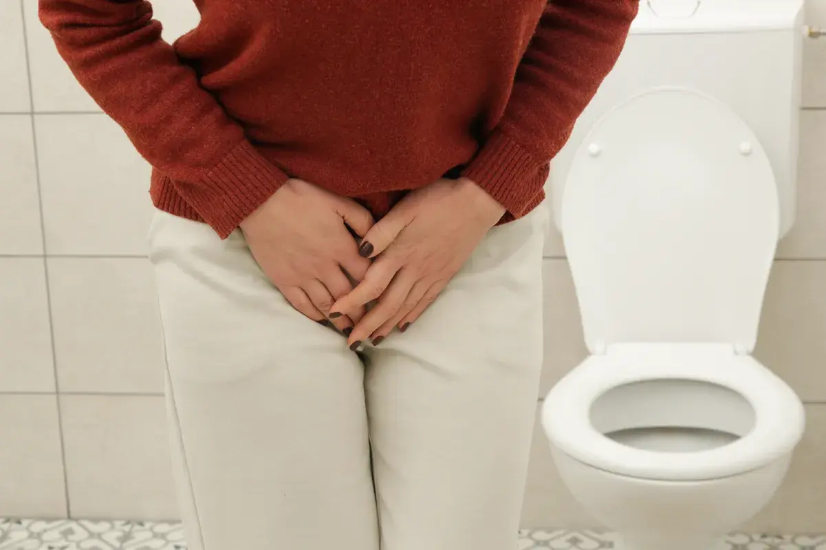 Woman having trouble peeing at the toilet