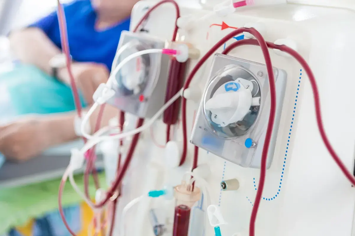 Medical dialysis machine with man in background