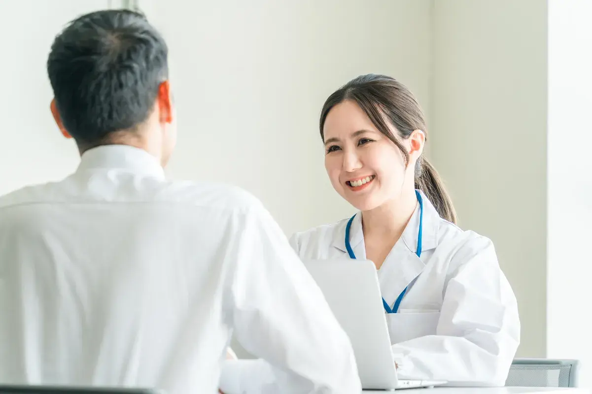 Doctor reviewing tablet results with hospitalized patient