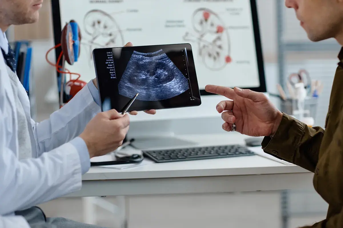 Doctor showing patient a kidney ultrasound on tablet
