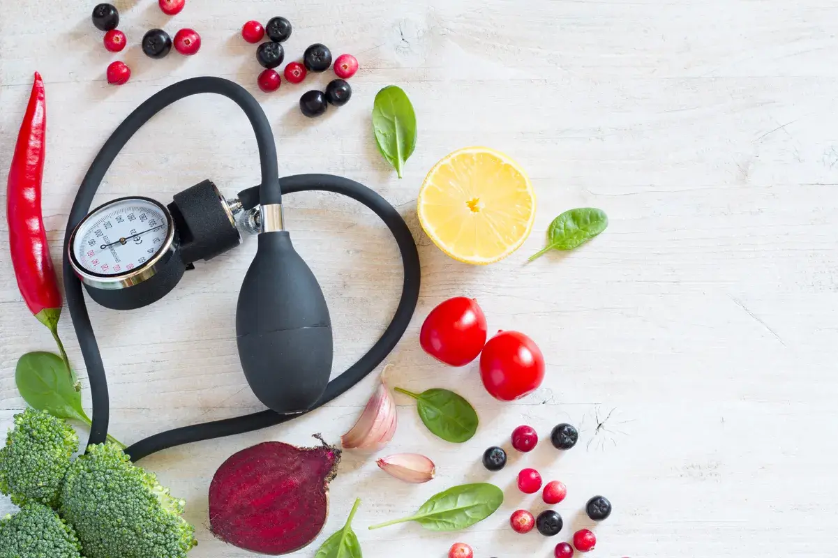 Blood pressure gauge surrounded by kidney-healthy foods