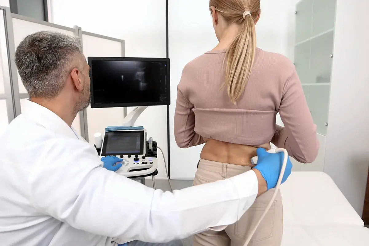 Doctor performing a kidney ultrasound scan on a patient